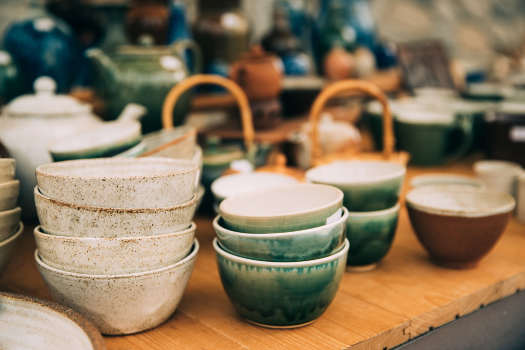 Ceramic Clay Crafts. Ceramic Dishware In Market. Bowls Of Different Sizes, Colors And Shapes.
